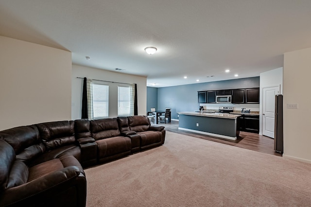 living area with dark colored carpet, visible vents, baseboards, and recessed lighting