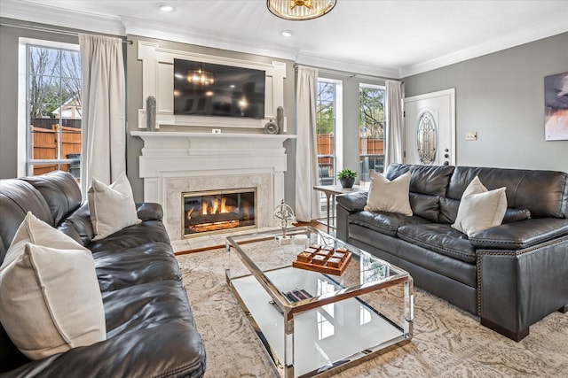 living area with recessed lighting, a high end fireplace, and crown molding