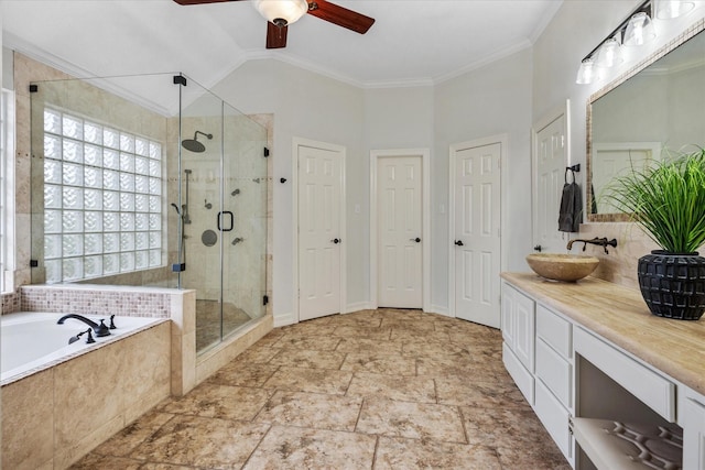 bathroom featuring a garden tub, a stall shower, ornamental molding, vanity, and vaulted ceiling