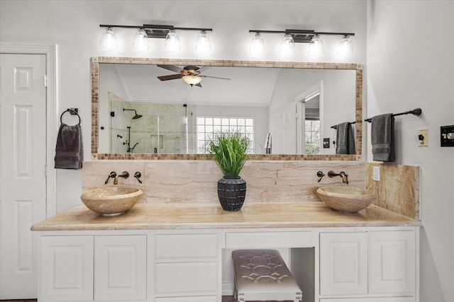 bathroom featuring a stall shower, lofted ceiling, a ceiling fan, and a sink