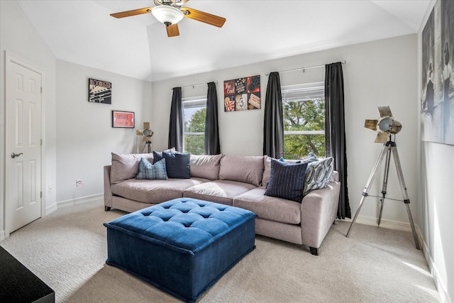 living area with a ceiling fan, lofted ceiling, light colored carpet, and baseboards