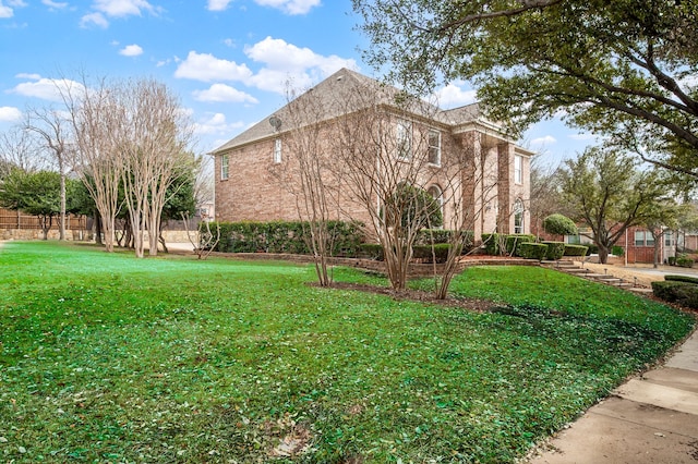 view of home's exterior featuring a lawn and fence