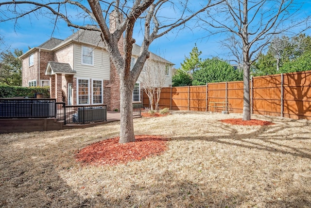 view of yard featuring a deck and a fenced backyard