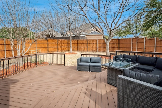 wooden terrace with a fenced backyard and an outdoor hangout area