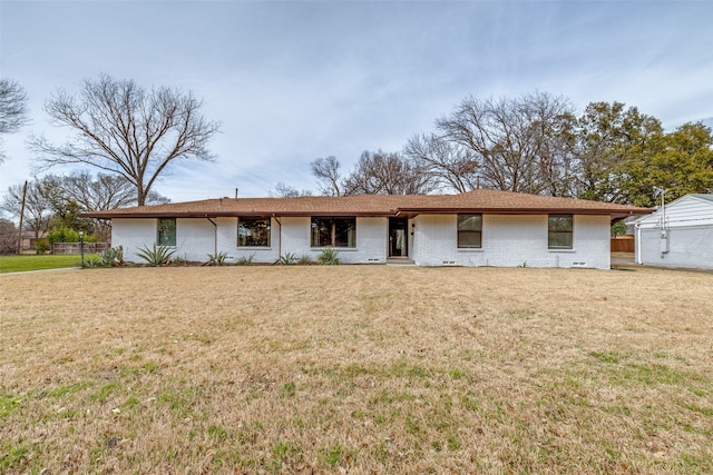 ranch-style home featuring a front yard and brick siding