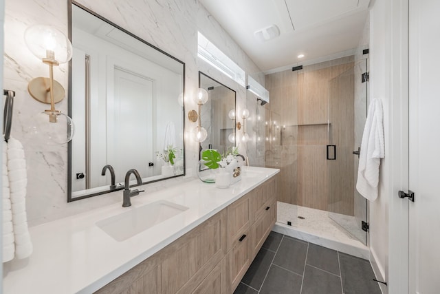 bathroom with double vanity, a stall shower, a sink, and tile patterned floors