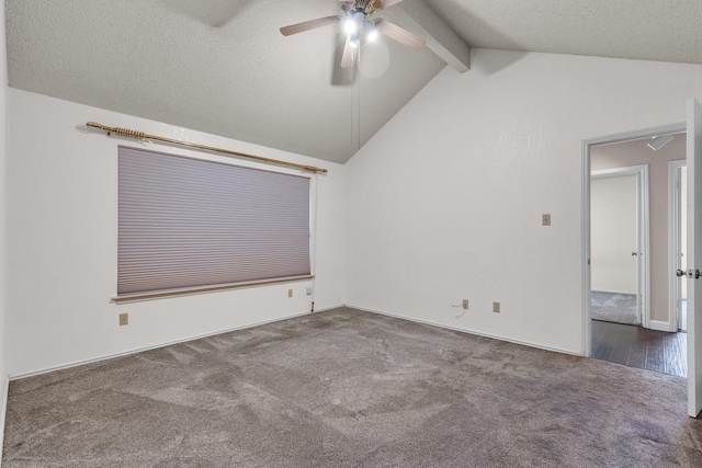 carpeted spare room featuring vaulted ceiling with beams, a textured ceiling, and ceiling fan