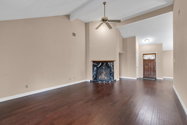 unfurnished living room with a fireplace, dark wood finished floors, visible vents, ceiling fan, and baseboards