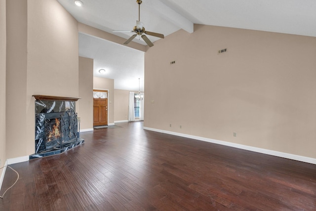 unfurnished living room featuring visible vents, a high end fireplace, wood finished floors, beamed ceiling, and baseboards