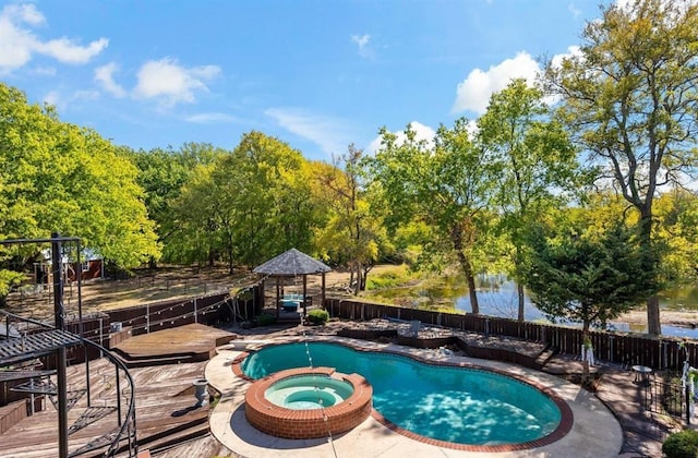 12900 Fm 121, Van Alstyne, TX 75495 - view of swimming pool featuring a deck with water view, fence, and a pool with connected hot tub