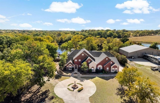 drone / aerial view featuring a wooded view