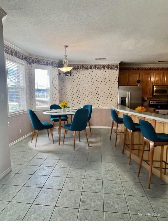 12900 Fm 121, Van Alstyne, TX 75495 - dining area featuring light tile patterned floors, wallpapered walls, baseboards, and a textured ceiling