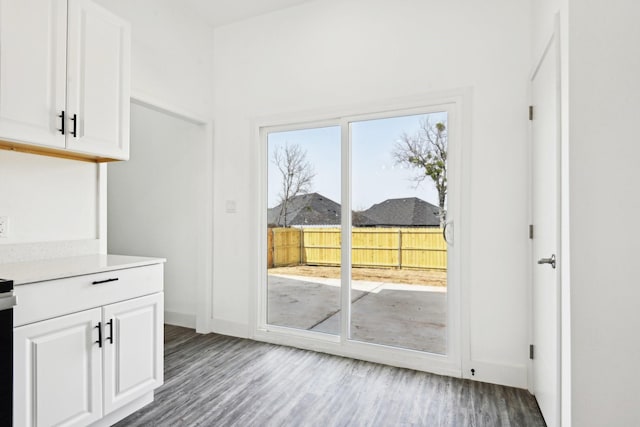 entryway with wood finished floors and baseboards