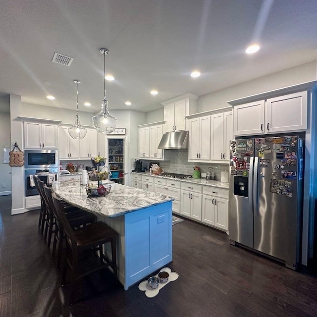 kitchen with visible vents, white cabinets, appliances with stainless steel finishes, dark wood-type flooring, and under cabinet range hood