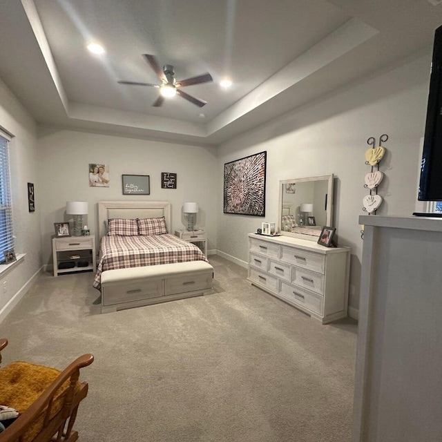 bedroom featuring baseboards, a raised ceiling, a ceiling fan, carpet flooring, and recessed lighting