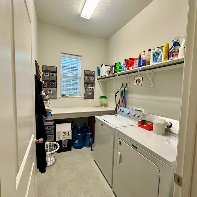 washroom with laundry area, separate washer and dryer, and a textured ceiling