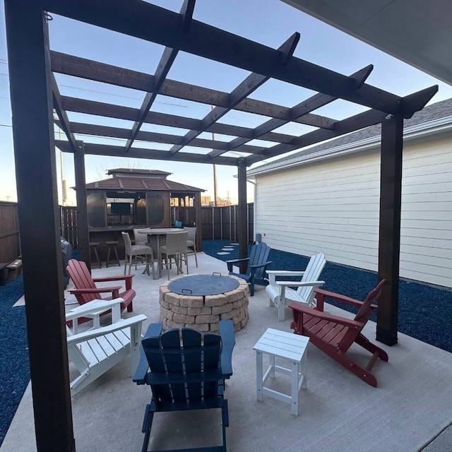 view of patio featuring an outdoor fire pit, outdoor dining area, fence, and a pergola