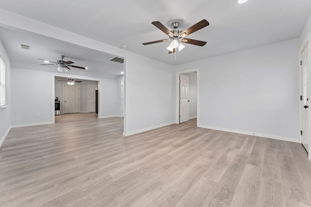 unfurnished living room with light wood-type flooring, baseboards, and visible vents