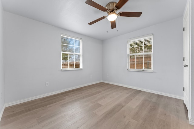 unfurnished room featuring a healthy amount of sunlight, light wood finished floors, baseboards, and a ceiling fan