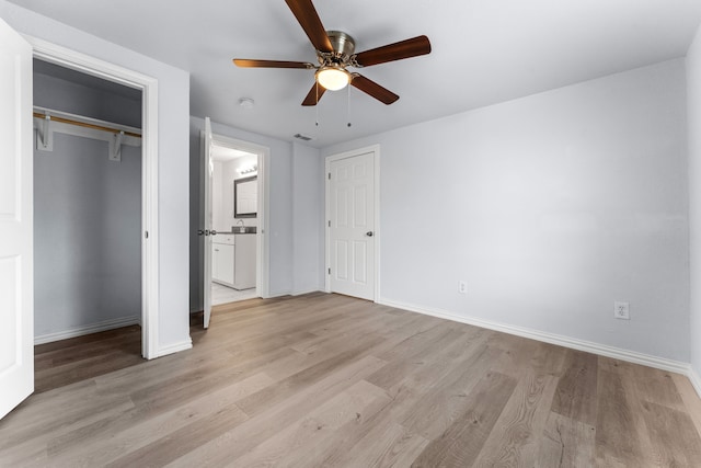 unfurnished bedroom featuring ceiling fan, light wood-type flooring, visible vents, and baseboards