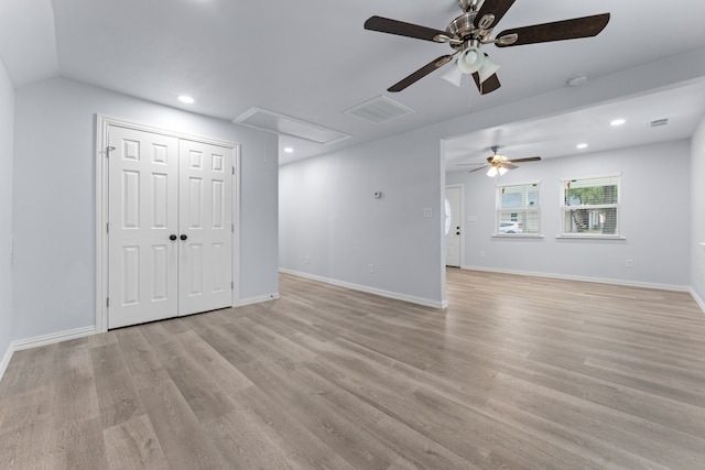 interior space with recessed lighting, visible vents, attic access, light wood-style floors, and baseboards