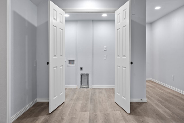 interior space featuring recessed lighting, baseboards, and wood finished floors