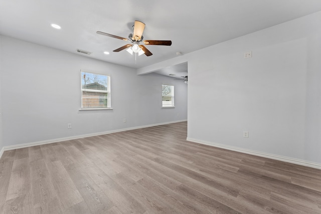 unfurnished room featuring recessed lighting, visible vents, light wood-style flooring, a ceiling fan, and baseboards