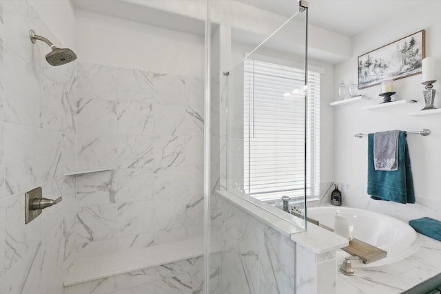 bathroom featuring a marble finish shower and a garden tub