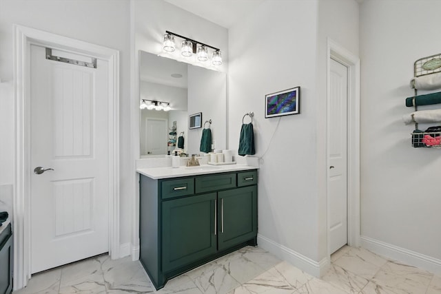 bathroom with vanity, baseboards, and marble finish floor