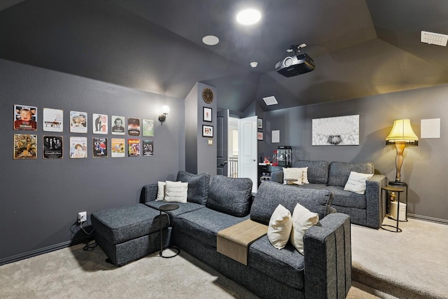 home theater room with visible vents, baseboards, lofted ceiling, and carpet