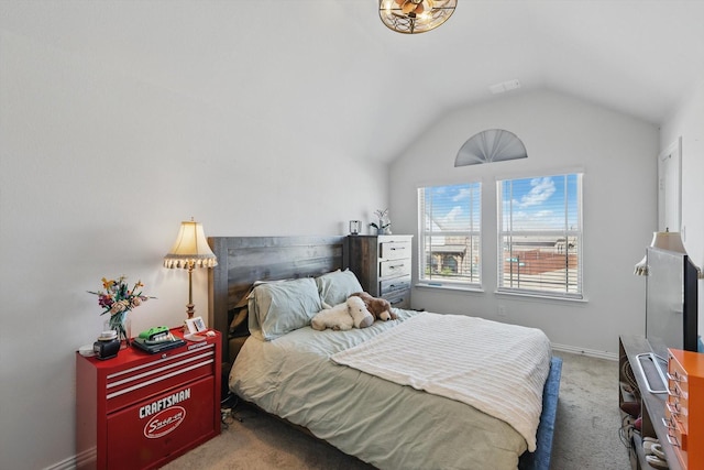 carpeted bedroom featuring baseboards and lofted ceiling