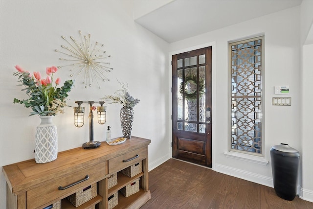 entryway featuring baseboards and dark wood finished floors