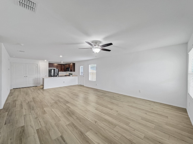 unfurnished living room featuring recessed lighting, a ceiling fan, baseboards, visible vents, and light wood-style floors