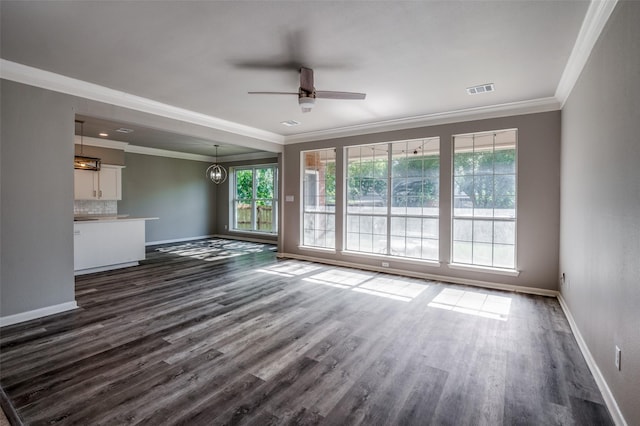 unfurnished living room featuring baseboards, visible vents, ceiling fan, ornamental molding, and dark wood-style flooring