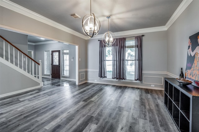 entryway with crown molding, visible vents, dark wood-type flooring, a chandelier, and stairs