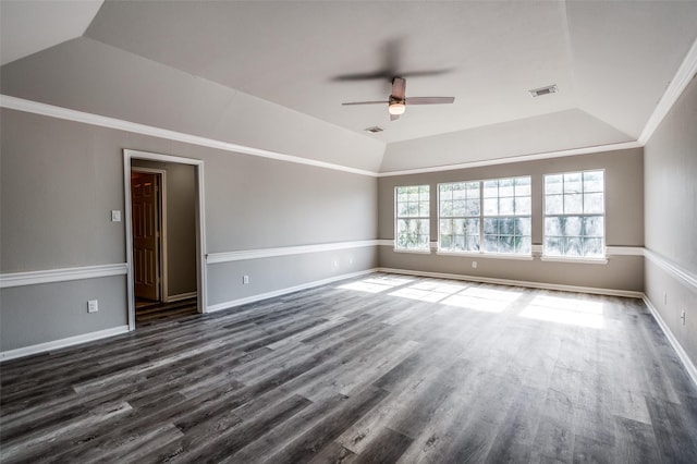 unfurnished room with lofted ceiling, dark wood-style floors, visible vents, and crown molding