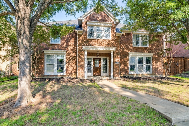 view of front of house with fence and a front lawn