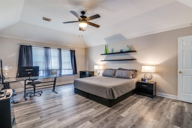 bedroom featuring vaulted ceiling, wood finished floors, visible vents, and baseboards