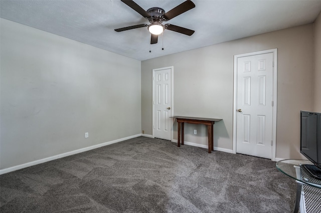 unfurnished bedroom with carpet floors, baseboards, and a ceiling fan