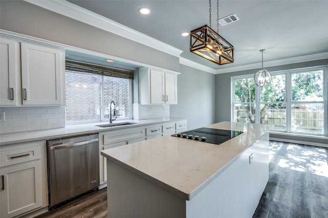 kitchen featuring black electric stovetop, visible vents, stainless steel dishwasher, ornamental molding, and a sink