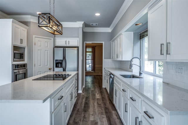 kitchen featuring stainless steel appliances, ornamental molding, a sink, and white cabinetry