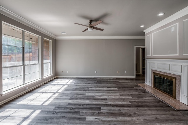 unfurnished living room featuring dark wood-style floors, baseboards, a fireplace, and ornamental molding