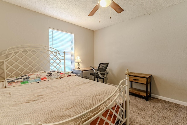 bedroom with baseboards, a textured wall, ceiling fan, carpet, and a textured ceiling