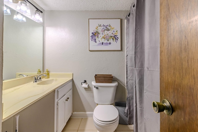 bathroom featuring baseboards, toilet, tile patterned flooring, a textured ceiling, and vanity