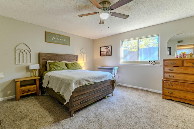 carpeted bedroom featuring visible vents, ceiling fan, a textured ceiling, and baseboards