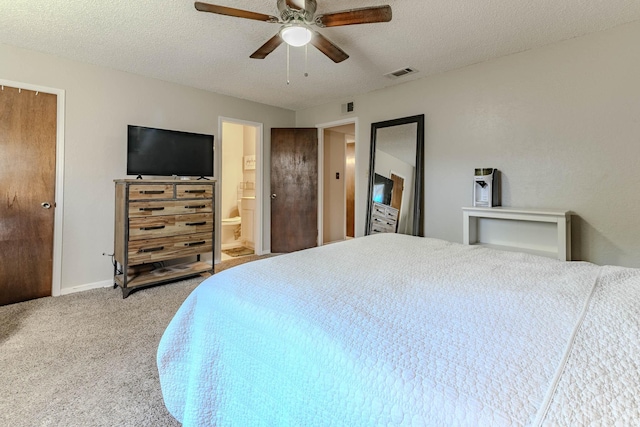 bedroom with a textured ceiling, carpet, visible vents, and baseboards