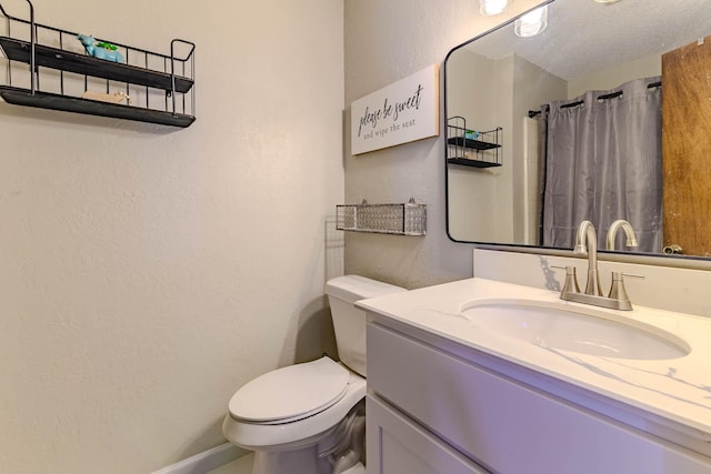 bathroom with a textured wall, toilet, curtained shower, a textured ceiling, and vanity