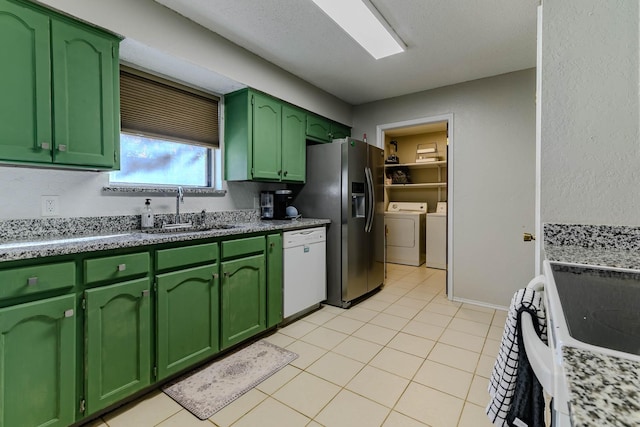 kitchen featuring stainless steel refrigerator with ice dispenser, a sink, separate washer and dryer, green cabinetry, and dishwasher