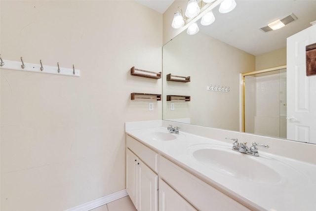 bathroom with double vanity, a stall shower, visible vents, and a sink