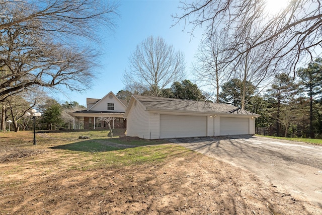 view of side of home with a garage, a yard, and an outdoor structure